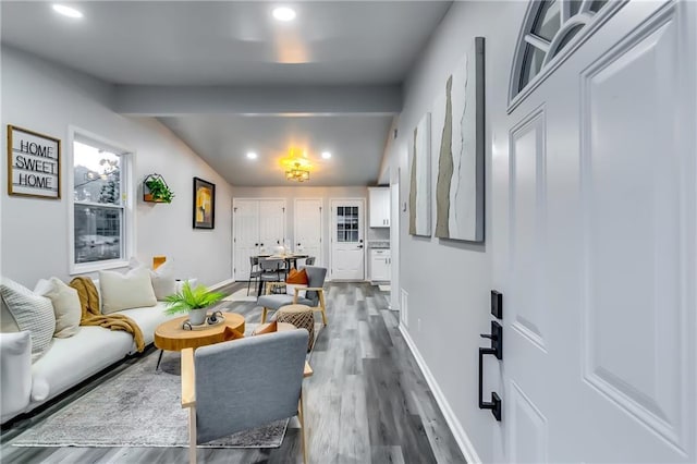 living room featuring dark hardwood / wood-style floors and vaulted ceiling with beams