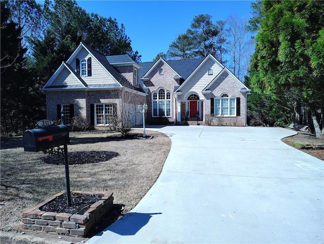 view of front of property featuring brick siding, concrete driveway, and a garage