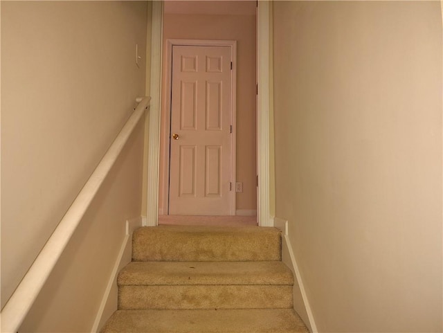 stairway featuring baseboards