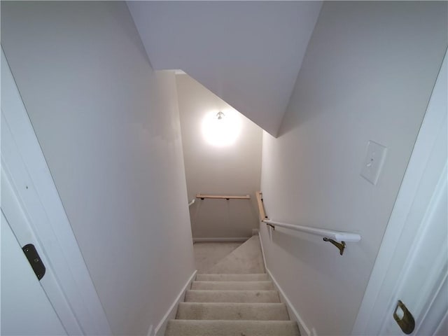 stairway featuring lofted ceiling