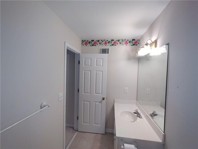 bathroom with visible vents, baseboards, vanity, and tile patterned flooring