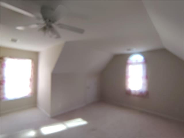 bonus room featuring ceiling fan and vaulted ceiling