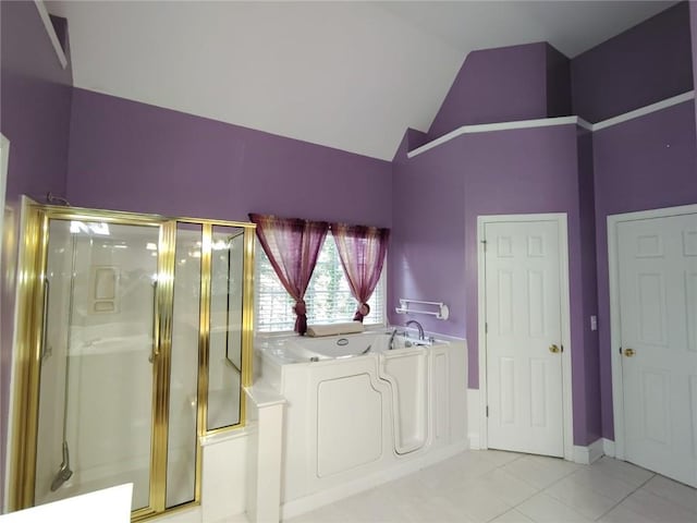 bathroom featuring tile patterned flooring, a shower stall, high vaulted ceiling, and a garden tub