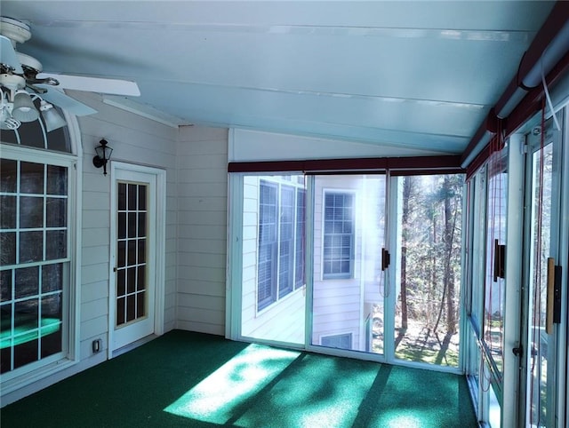 unfurnished sunroom with lofted ceiling, plenty of natural light, and ceiling fan