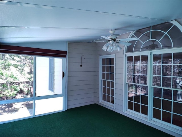 unfurnished sunroom featuring a ceiling fan and vaulted ceiling