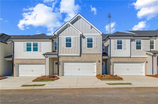 multi unit property with a garage, concrete driveway, and board and batten siding