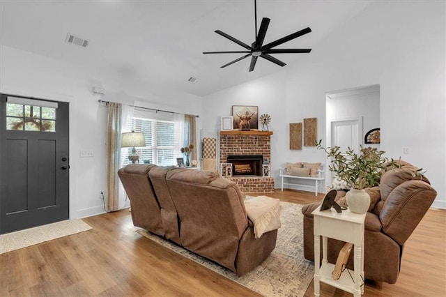 3088 Hiram Sudie Rd, Hiram, GA 30141 - living room featuring ceiling fan, a fireplace, light wood-type flooring, and high vaulted ceiling
