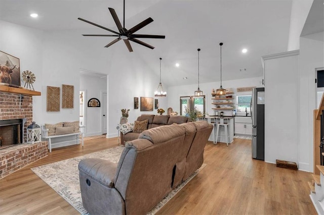 3088 Hiram Sudie Rd, Hiram, GA 30141 - living room with a brick fireplace, a ceiling fan, high vaulted ceiling, light wood-type flooring, and recessed lighting