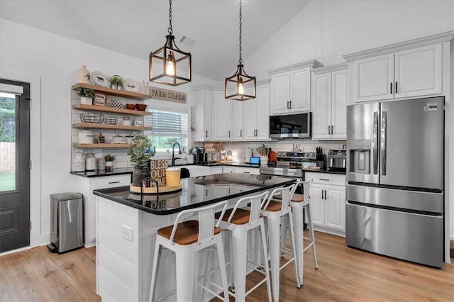 3088 Hiram Sudie Rd, Hiram, GA 30141 - kitchen with stainless steel appliances, tasteful backsplash, white cabinets, dark countertops, and open shelves