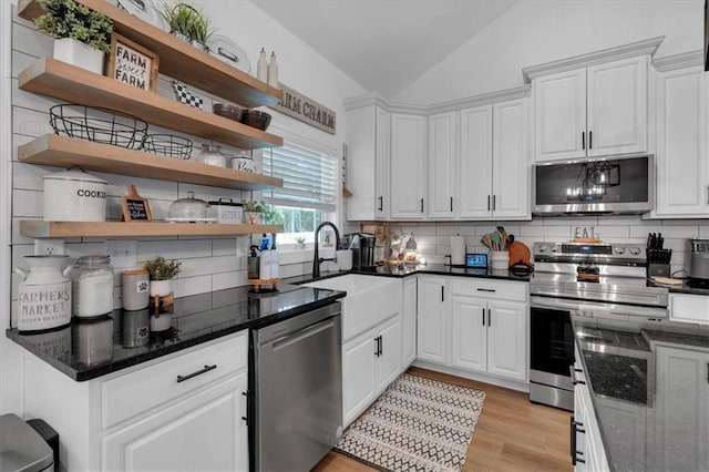 3088 Hiram Sudie Rd, Hiram, GA 30141 - kitchen featuring stainless steel appliances, open shelves, vaulted ceiling, backsplash, and white cabinets