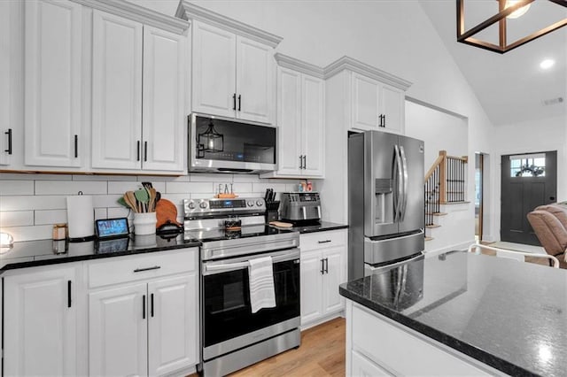 3088 Hiram Sudie Rd, Hiram, GA 30141 - kitchen featuring appliances with stainless steel finishes, white cabinetry, backsplash, high vaulted ceiling, and light wood finished floors