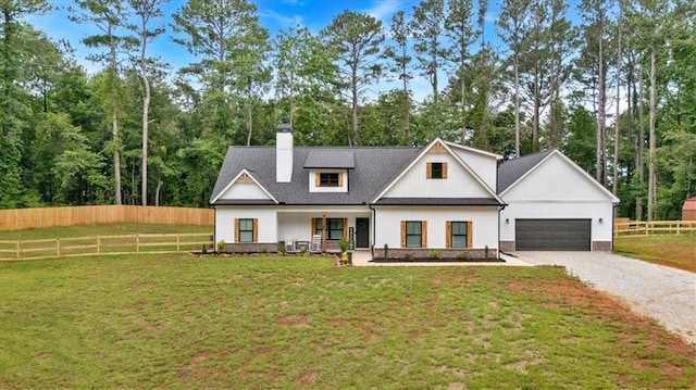 3088 Hiram Sudie Rd, Hiram, GA 30141 - modern farmhouse with a chimney, covered porch, a garage, and view of scattered trees