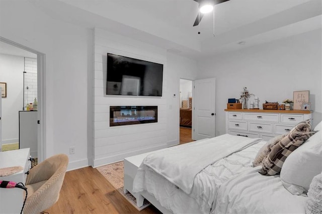 3088 Hiram Sudie Rd, Hiram, GA 30141 - bedroom with light wood-type flooring, a fireplace, and a ceiling fan