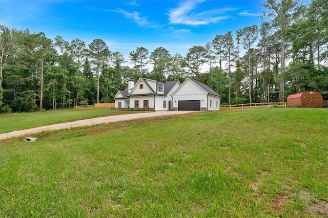 3088 Hiram Sudie Rd, Hiram, GA 30141 - view of front of home with driveway, a storage unit, a garage, and view of scattered trees