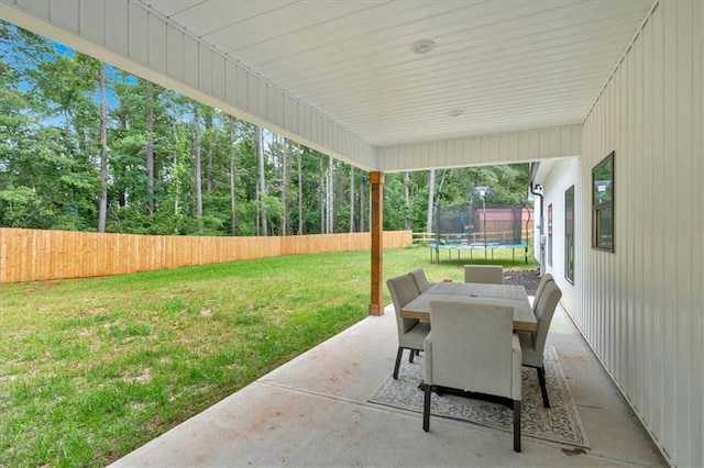 3088 Hiram Sudie Rd, Hiram, GA 30141 - fenced backyard featuring a trampoline, a patio area, and outdoor dining space