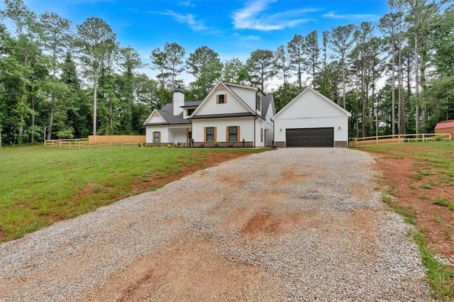 3088 Hiram Sudie Rd, Hiram, GA 30141 - modern farmhouse featuring a detached garage, a chimney, view of scattered trees, and driveway