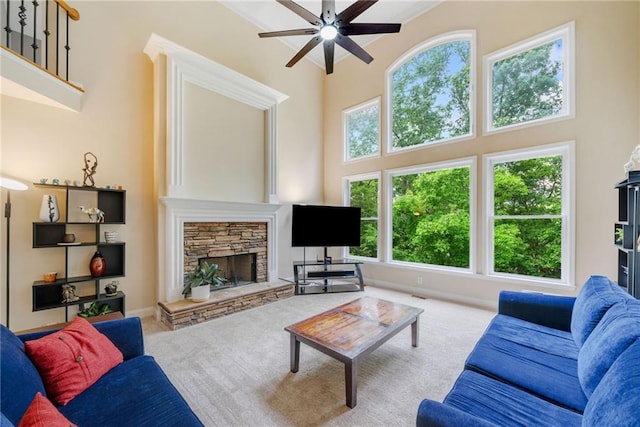 420 Big Bend Trl, Sugar Hill, GA 30518 - carpeted living room featuring a ceiling fan, a towering ceiling, a stone fireplace, and baseboards