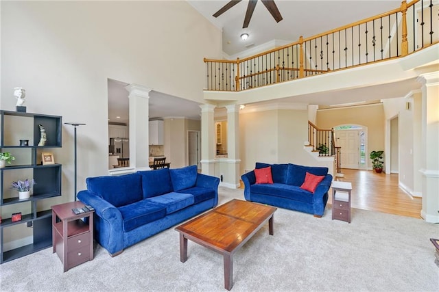 420 Big Bend Trl, Sugar Hill, GA 30518 - carpeted living room featuring high vaulted ceiling, ceiling fan, stairway, decorative columns, and baseboards