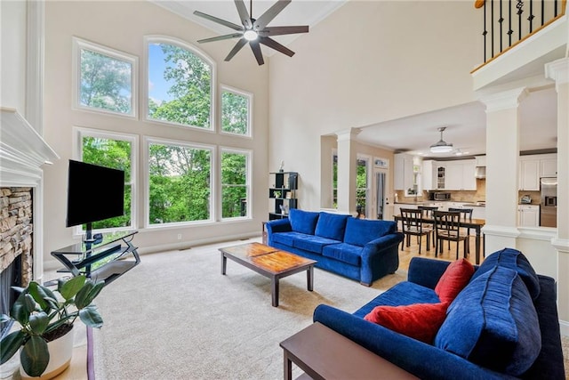 420 Big Bend Trl, Sugar Hill, GA 30518 - living room featuring ceiling fan, decorative columns, a fireplace, a high ceiling, and carpet flooring