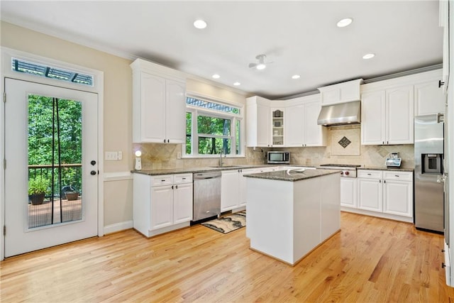 420 Big Bend Trl, Sugar Hill, GA 30518 - kitchen with appliances with stainless steel finishes, under cabinet range hood, white cabinets, light wood finished floors, and recessed lighting