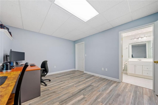 420 Big Bend Trl, Sugar Hill, GA 30518 - home office with wood finished floors, a paneled ceiling, a sink, and baseboards