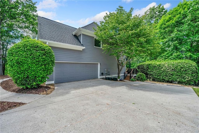420 Big Bend Trl, Sugar Hill, GA 30518 - view of side of property featuring driveway, a shingled roof, and a garage