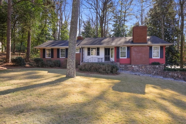 ranch-style home with covered porch and a front yard