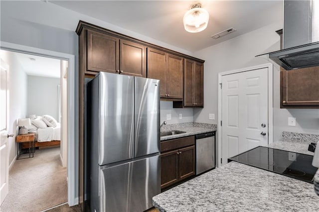 110 Chalfont Cir, Carrollton, GA 30117 - kitchen featuring appliances with stainless steel finishes, island range hood, dark brown cabinets, a sink, and light stone counters