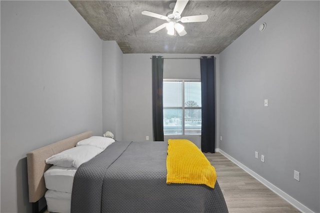 bedroom with ceiling fan and light hardwood / wood-style floors