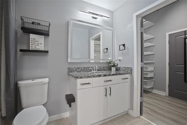 bathroom with vanity, hardwood / wood-style floors, and toilet