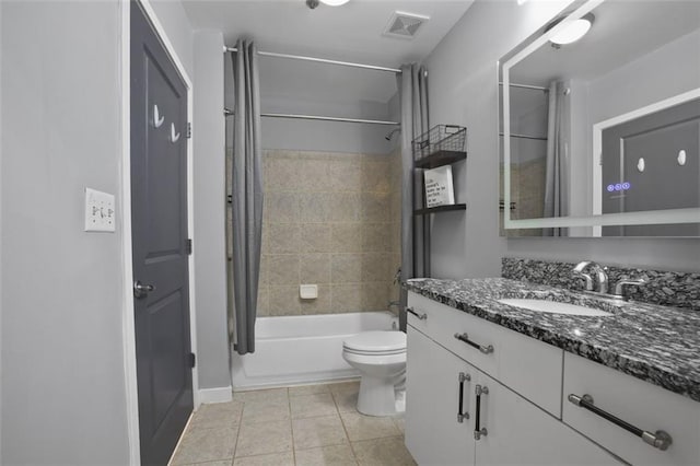 full bathroom with tile patterned floors, toilet, shower / bath combo with shower curtain, and vanity