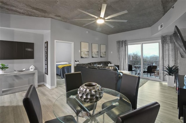 dining area with ceiling fan and light wood-type flooring