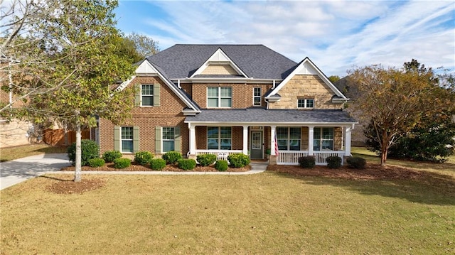 craftsman inspired home with covered porch and a front yard