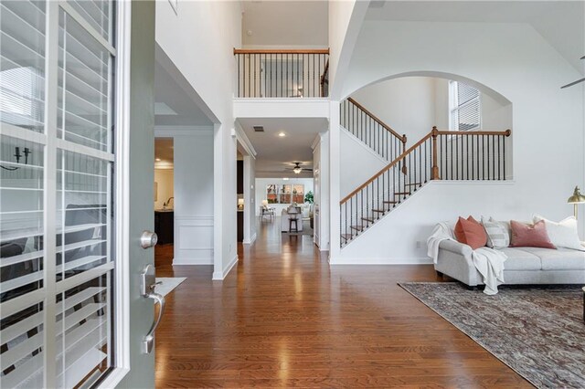 entryway with ceiling fan, high vaulted ceiling, and dark hardwood / wood-style floors