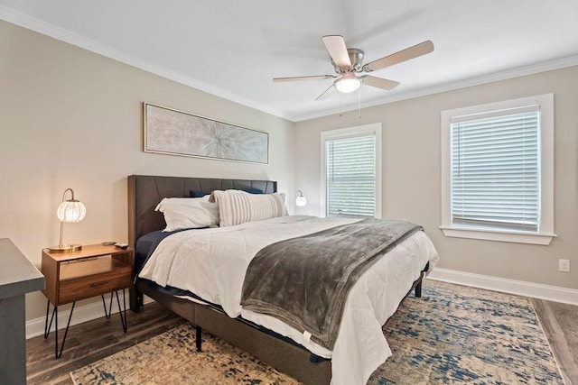 bedroom with dark wood-type flooring, ornamental molding, baseboards, and a ceiling fan