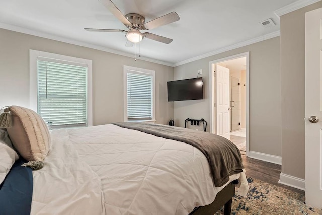 bedroom featuring dark wood finished floors, visible vents, ornamental molding, ensuite bath, and baseboards