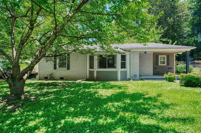 view of front facade with crawl space, a front lawn, and brick siding