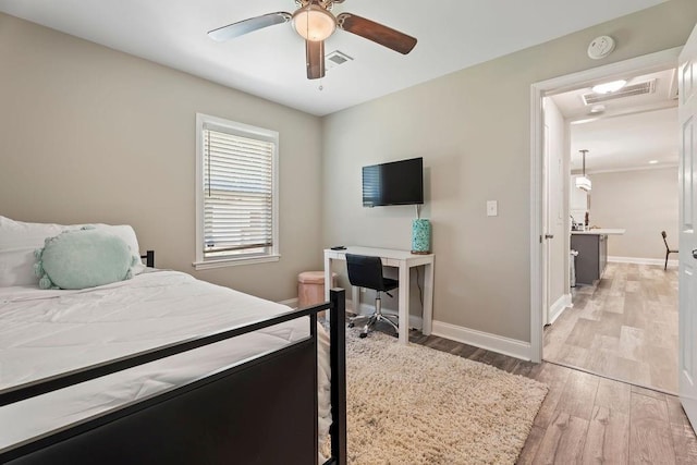 bedroom with light wood-style flooring, visible vents, and baseboards