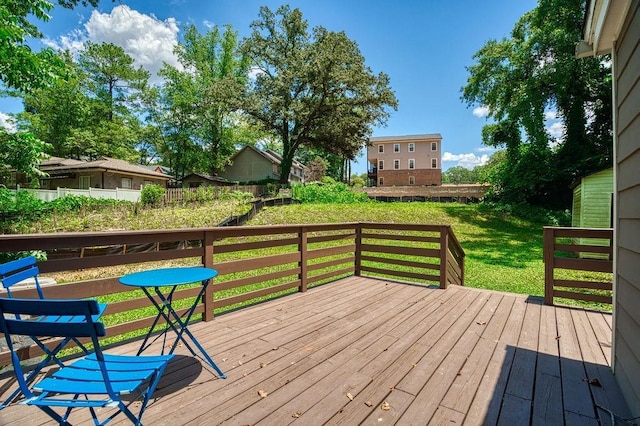 wooden deck with a lawn