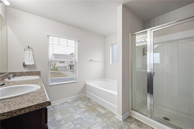 bathroom with vanity and separate shower and tub