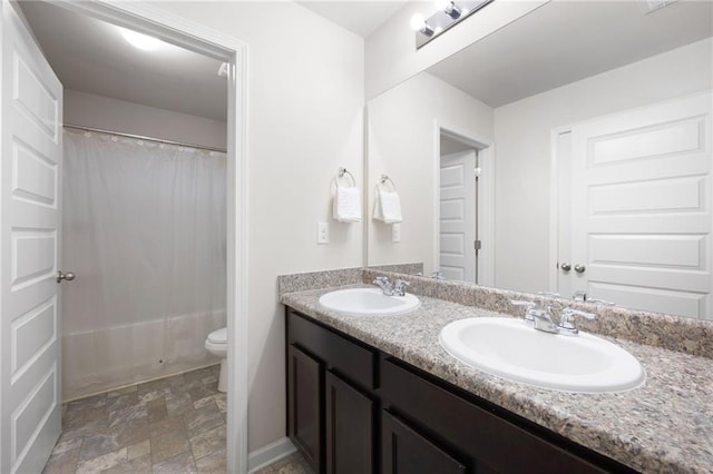 full bathroom featuring shower / bath combination with curtain, vanity, and toilet