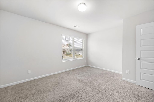 unfurnished room featuring carpet