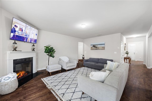 living room with dark hardwood / wood-style flooring