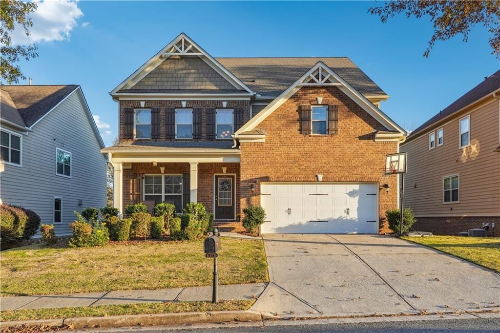 craftsman-style house featuring a front yard and a garage