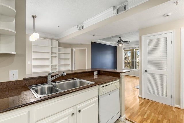 kitchen with white cabinetry, crown molding, dishwasher, and sink