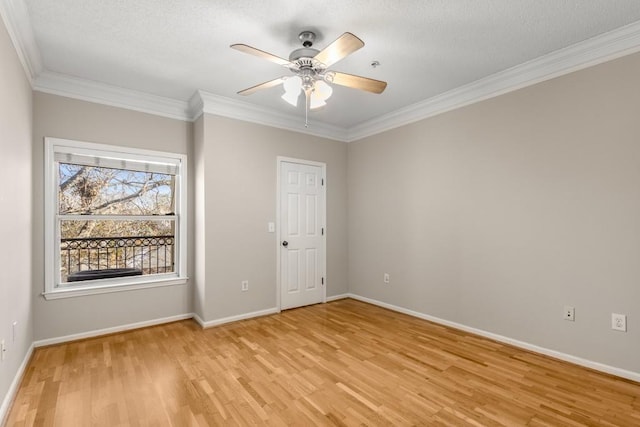 spare room with ceiling fan, ornamental molding, and light wood-type flooring