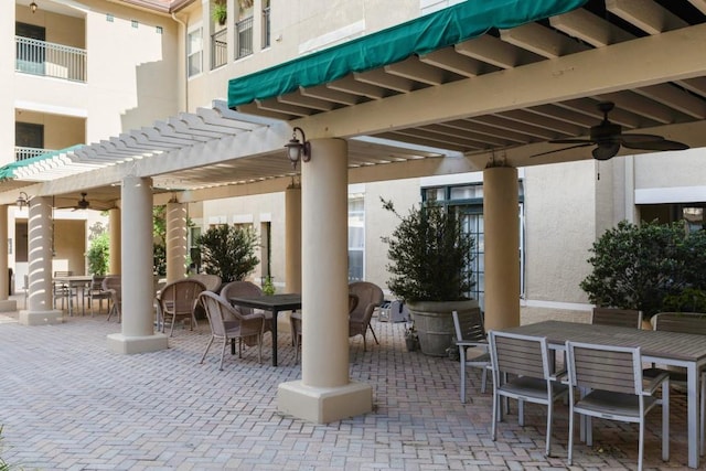 view of patio / terrace with ceiling fan and a pergola