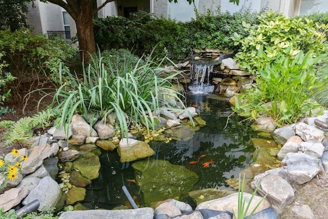 exterior details with a small pond