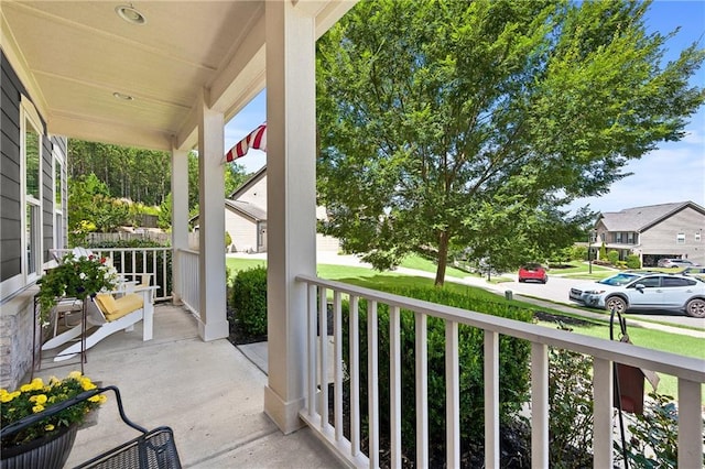 balcony featuring covered porch and a residential view