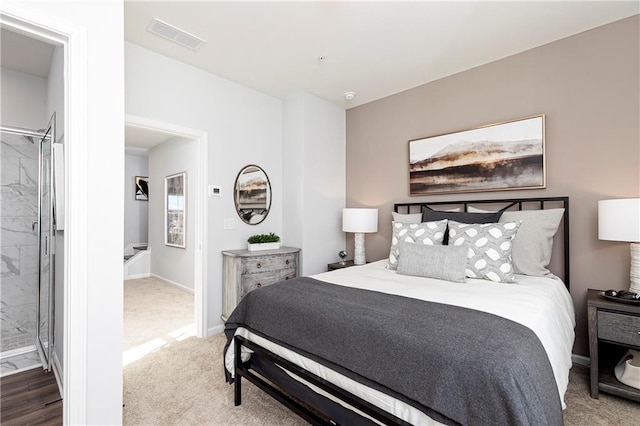 carpeted bedroom featuring visible vents and baseboards